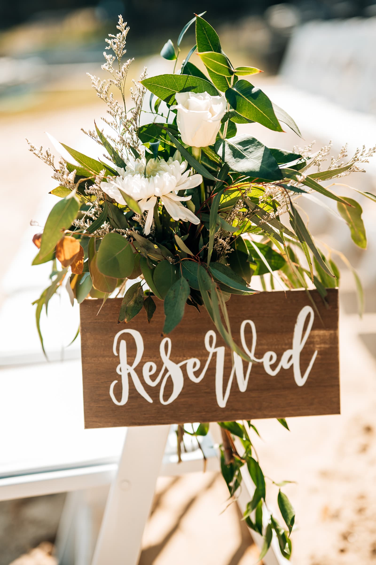A decorative sign reading "Reserved" surrounded by greenery and flowers.