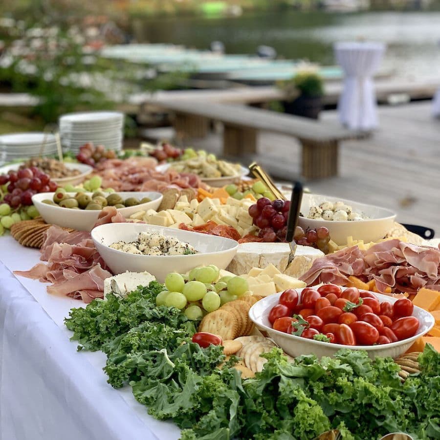 A beautifully arranged charcuterie table featuring various cheeses, meats, fruits, and crackers.